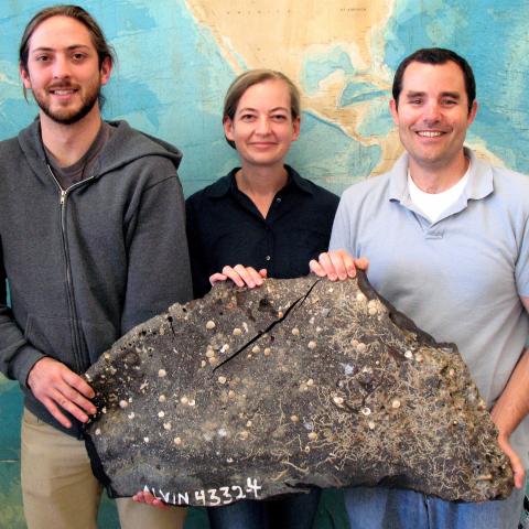 UCSB scientists holding a large piece of asphalt from SB Channel