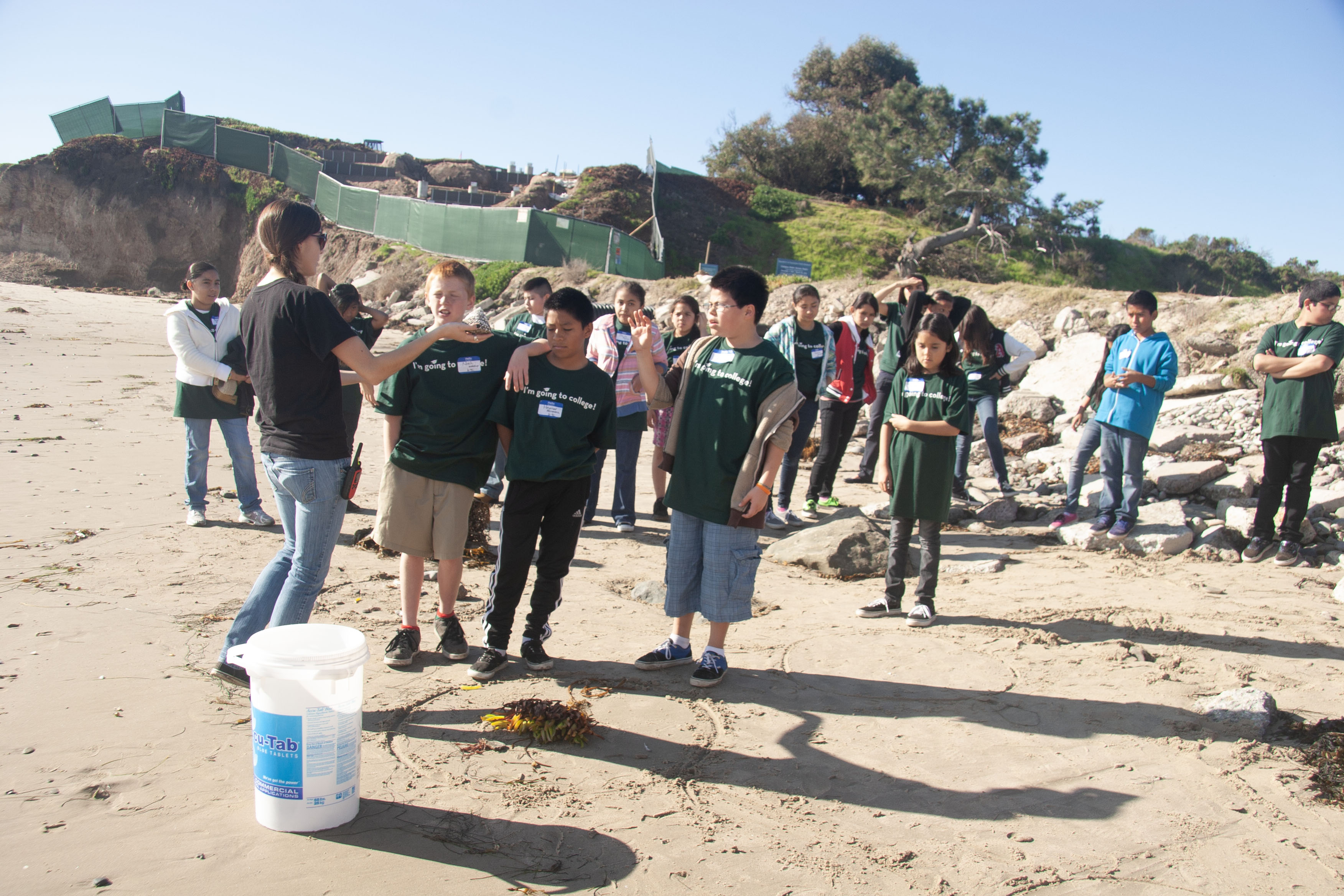 Group of sixth graders at campus point listening to undergrad docent