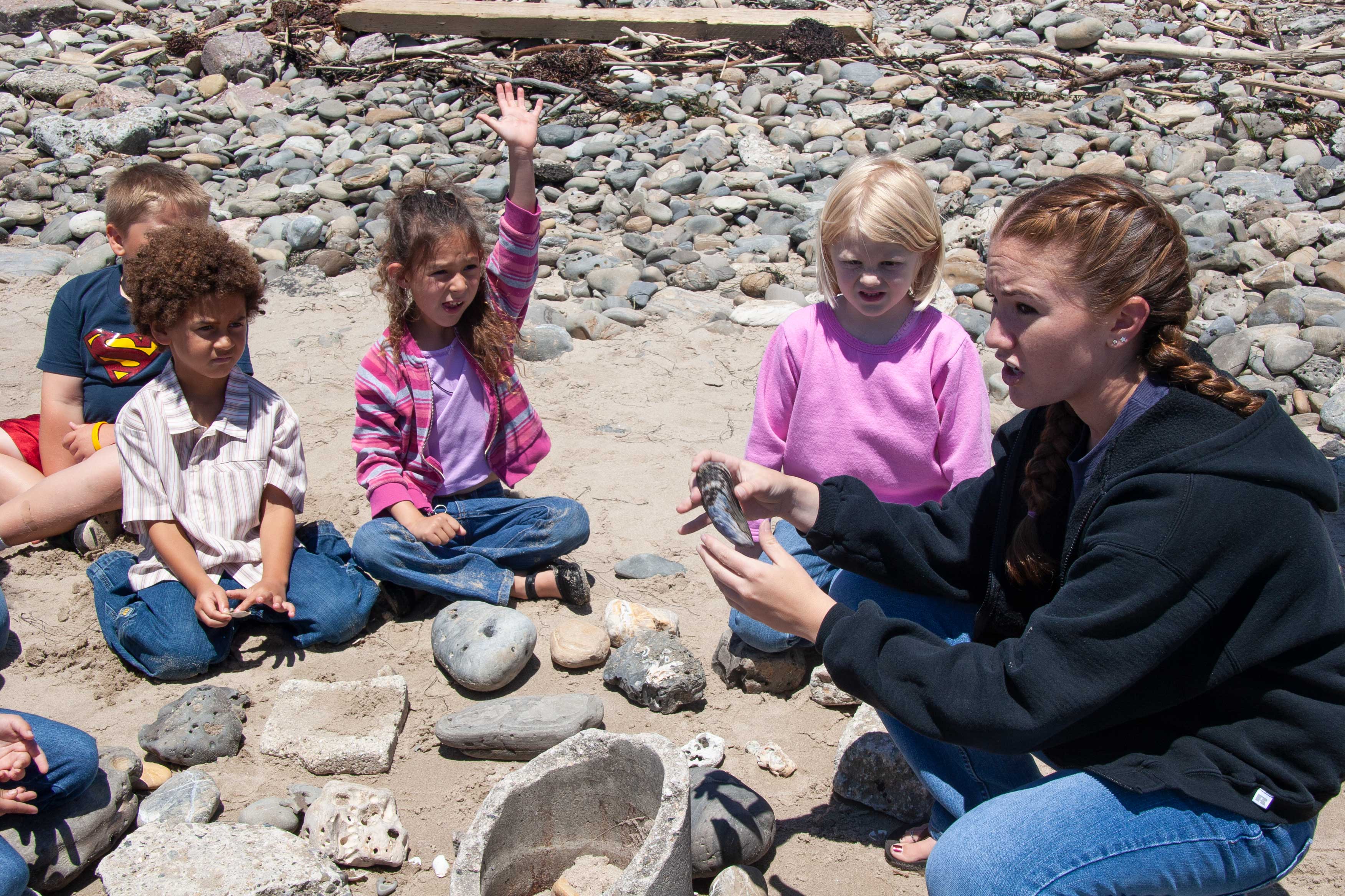 UCSB student shows shells to school kids outdoor