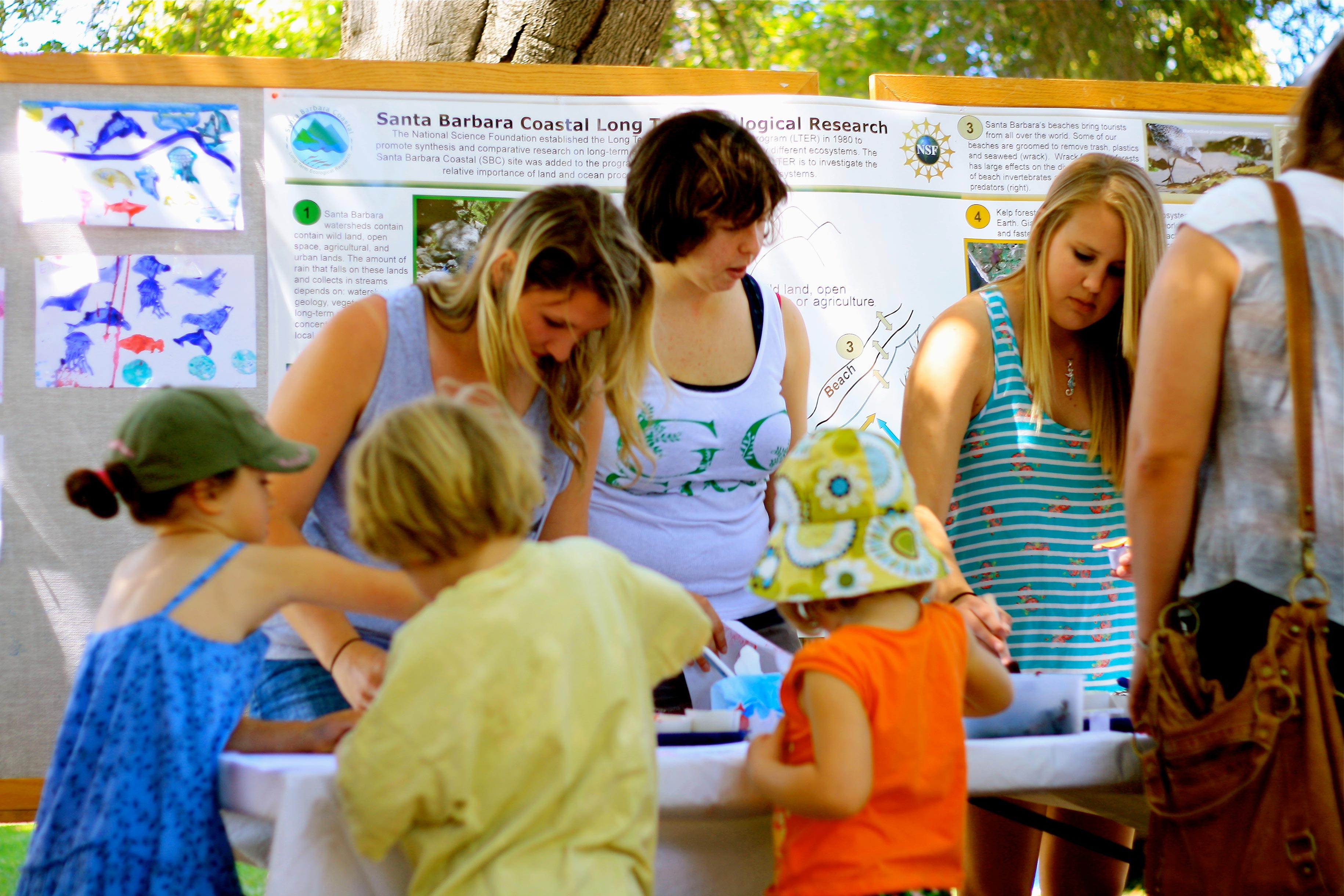 SB LTER booth surrounded by kids at Earth Day