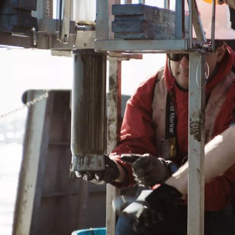 Postdoctoral student Sebastian Krause works to retrieve a tube of sediment collected from the seafloor