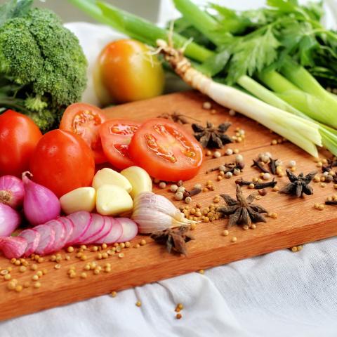 Cutting board with colorful vegetables and nuts