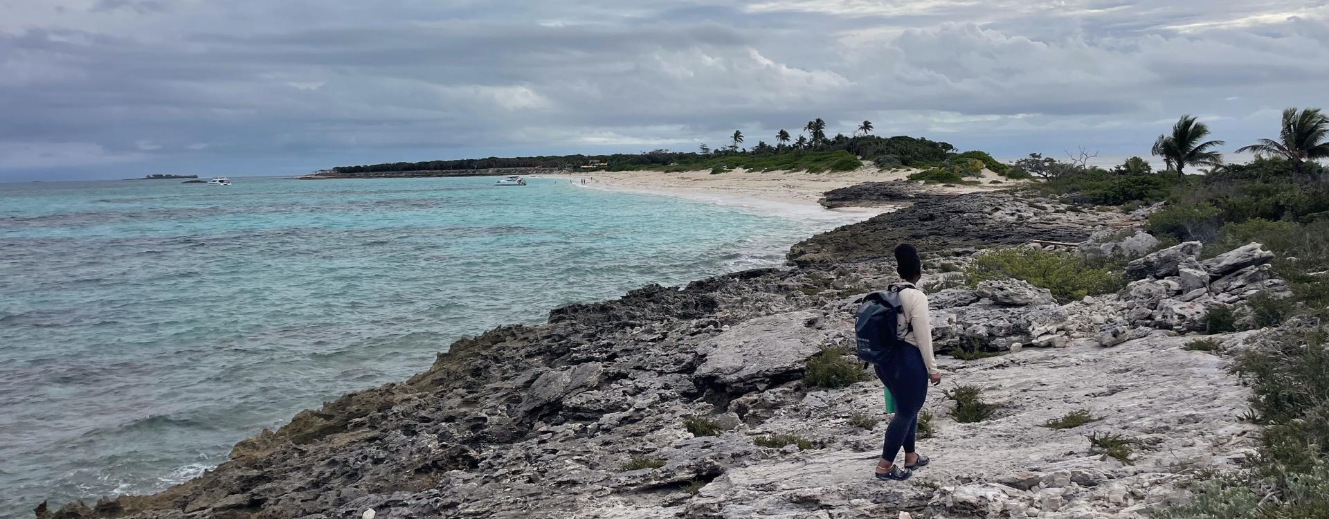 Northern side of Rose Island, Divina walking long the rocky shore to the CoastSnap site