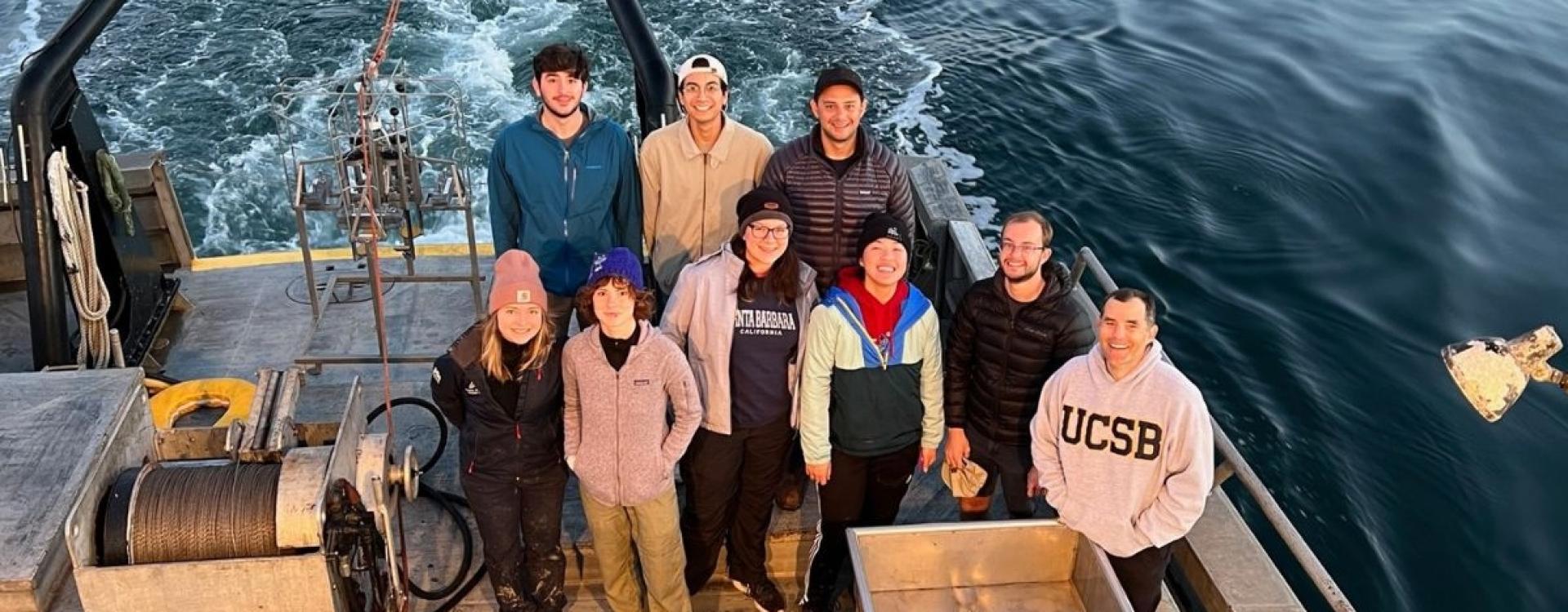 Valentine and students on a boat deck in the ocean