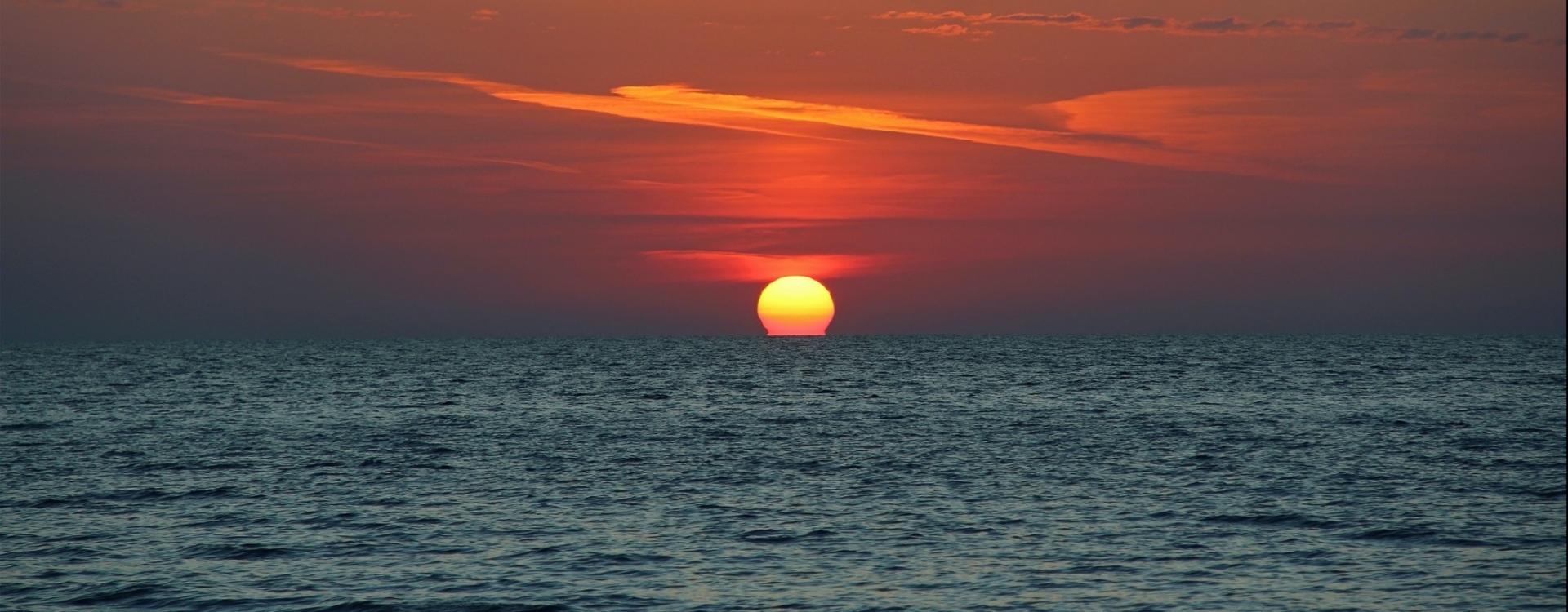 the sun sinks behind the horizon of the Black Sea
