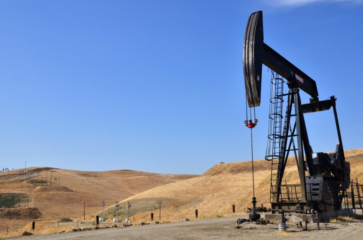 Pumpjack on a deserted site against blue sky