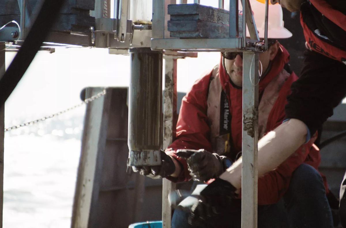 Postdoctoral student Sebastian Krause works to retrieve a tube of sediment collected from the seafloor