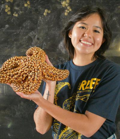 Isabella Ramirez holds a huge sea star at The REEF